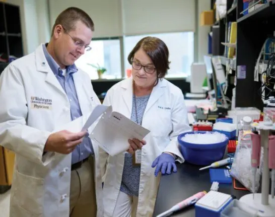 Two prostate cancer researchers review findings together in a medical laboratory.