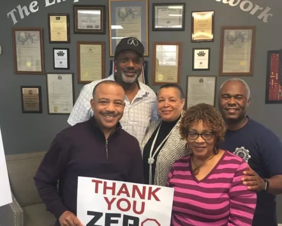 The Empowerment Network and holding up a sign saying thank you ZERO