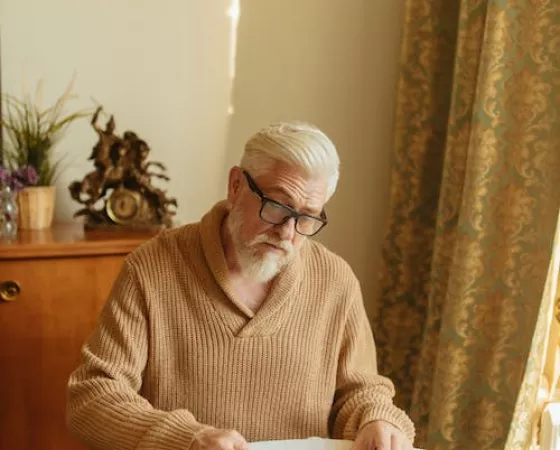 Man in Brown Knitted Sweater Organizing the Medicines