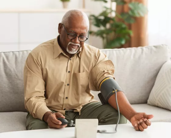 An older Black man taking his blood pressure test