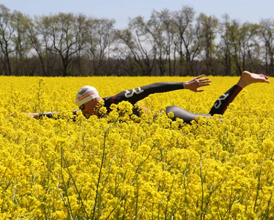 Tyler Myers going for a swim through a field of flowers decked out in full swim garb and cap