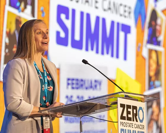 A blonde woman, Shelby Moneer, standing at a podium during the ZERO Summit 2023