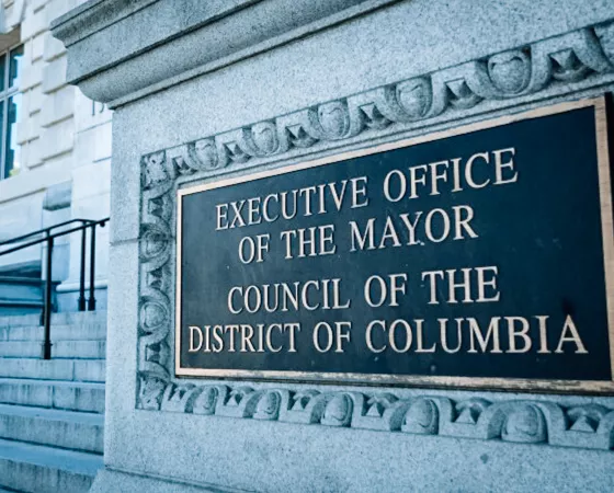 Outdoor sign that says "EXECUTIVE OFFICE OF THE MAYOR COUNCIL OF THE DISTRICT OF COLUMBIA"