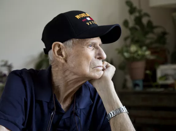 White elderly man with a veteran's hat