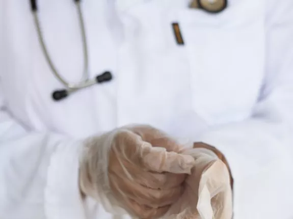 doctor putting on gloves
