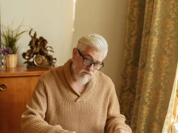 Man in Brown Knitted Sweater Organizing the Medicines