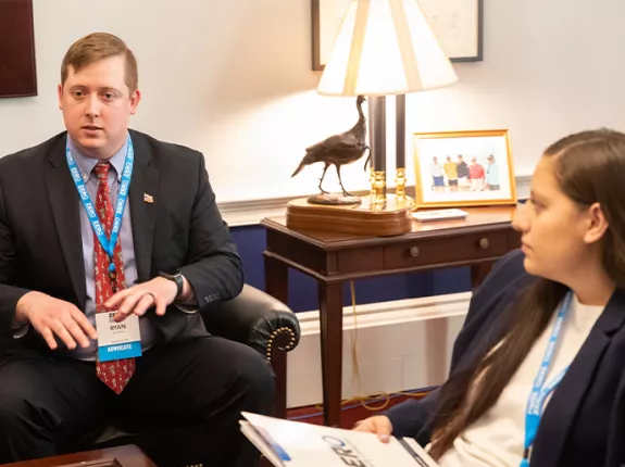 Two advocates sitting in a room at the Capitol 