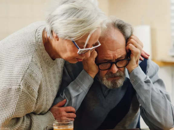 Heterosexual couple looking at documents looking distressed