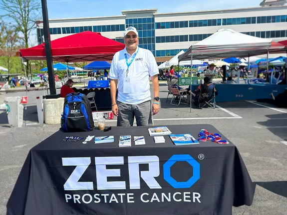Eric Morrow standing behind a ZERO table at an event