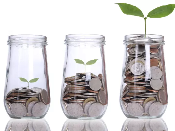 Three glass jars with metal coins in them