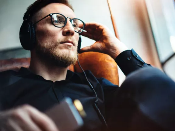 Man sitting in chair with headphones on