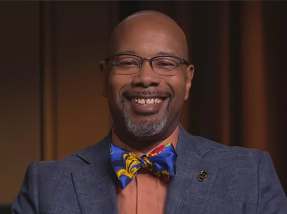 Dr. Kelvin Moses smiling with a big bow tie
