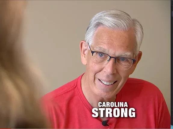 Prostate cancer survivor, Bob Lane, speaking to someone out-of-frame for a news segment called Carolina Strong