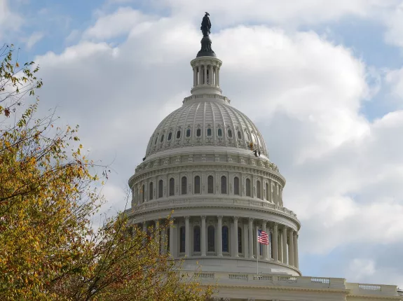 The dome of the Capitol against a sky with clouds