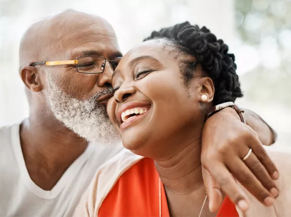 Old man giving a woman a kiss on the cheek