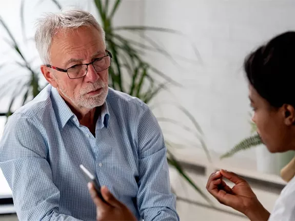 A white man sitting in across from his doctor