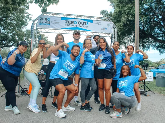 A large group of people wearing Run/Walk shirts in front of a start line