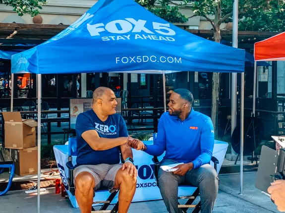 ZERO Champion, Eric Morrow, shaking hands with a reporter from FOX 5 in DC 