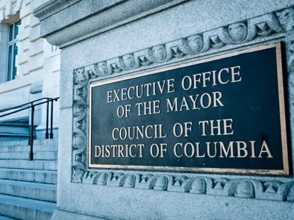 Outdoor sign that says "EXECUTIVE OFFICE OF THE MAYOR COUNCIL OF THE DISTRICT OF COLUMBIA"