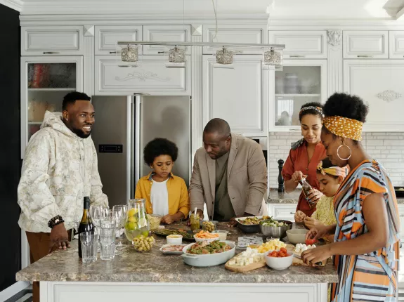 Black family gathered around kitchen table