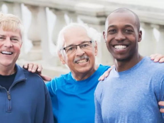 Group of men smiling wearing blue