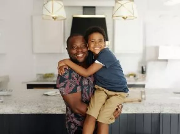 father_and_son_hugging_kitchen_banner