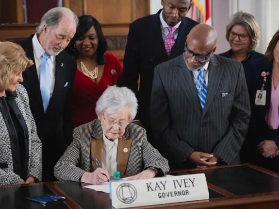 Picture of Alabama representatives signing documents 
