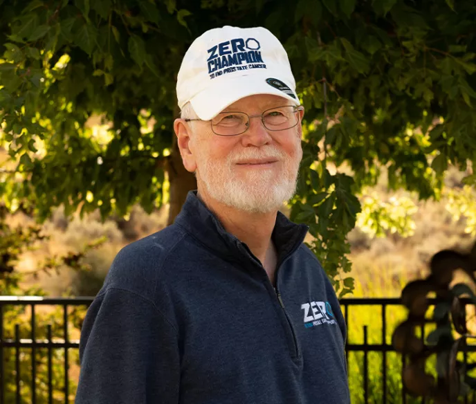 ZERO Champion Darrell Wilson standing in front of greenery