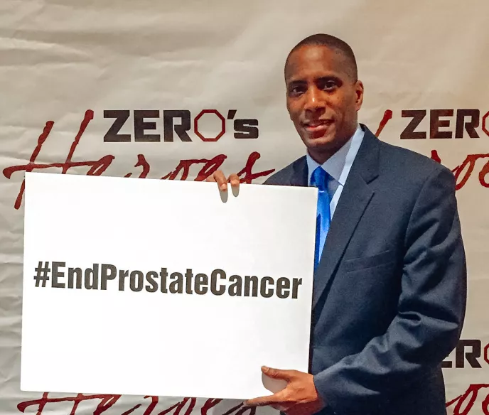 African American men holding a sign "End Prostate Cancer"