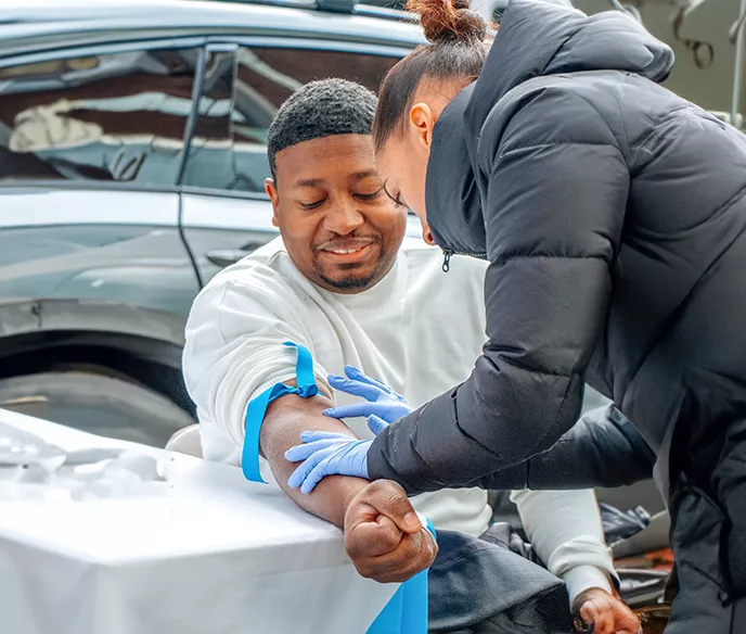 Black man receiving a free PSA screening test at a mobile event
