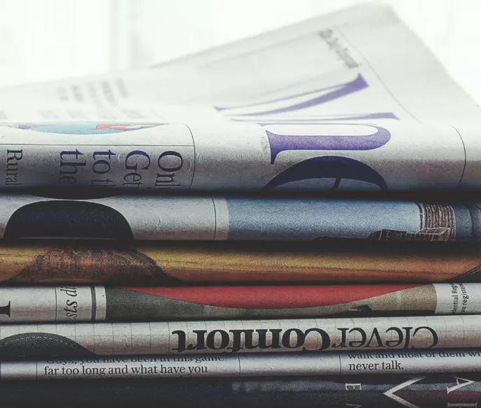 Newspapers stacked on top of one another