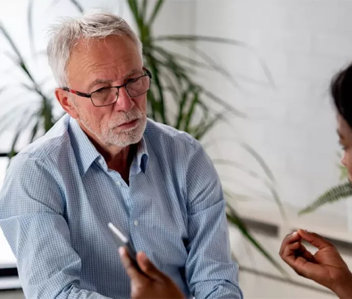 A white man sitting in across from his doctor