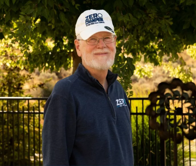 Darrell Wilson wearing blue shirt and white baseball cap