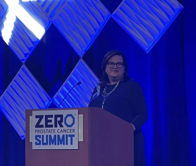 Shawn Supers behind a podium with a sign that says ZERO Prostate Cancer Summit