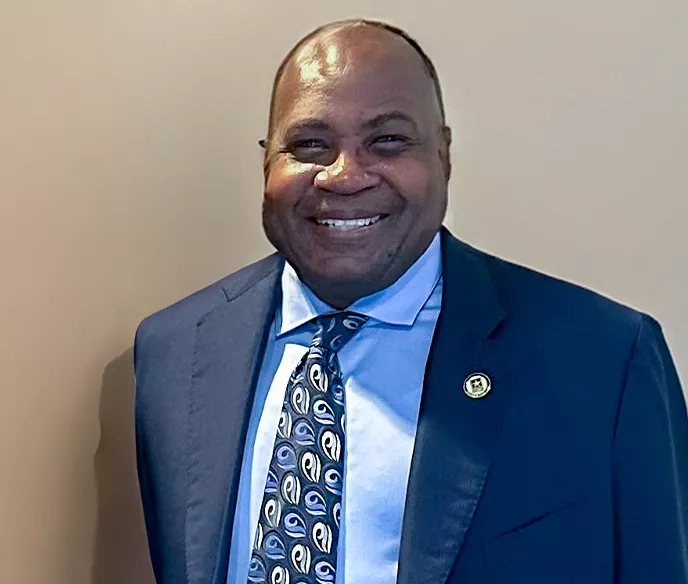 A Black man in a blue suit and tie