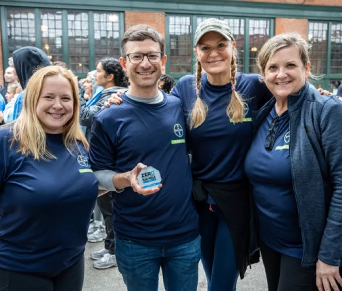 Picture of Team Bayer in matching dark blue shirts outside