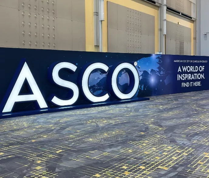 Sign that says "ASCO" in the middle of a large hallway