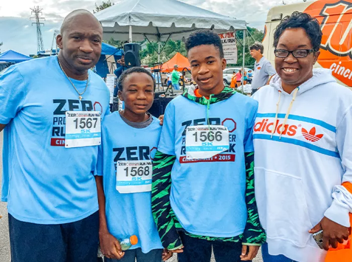 A Black family with a dad, two sons, and a mom