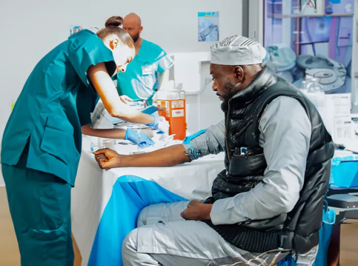Black man getting blood drawn by a nurse for a PSA test