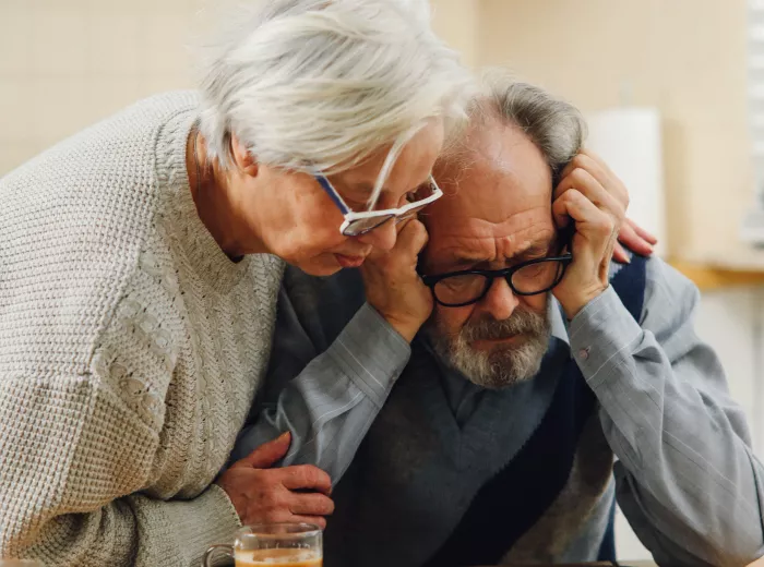 Heterosexual couple looking at documents looking distressed