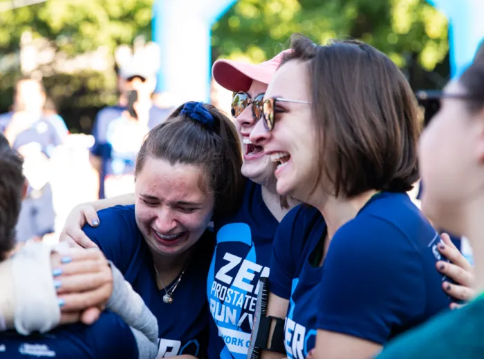 Three women hugging each other and crying