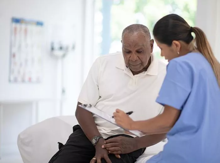 African American male patient talking to his doctor