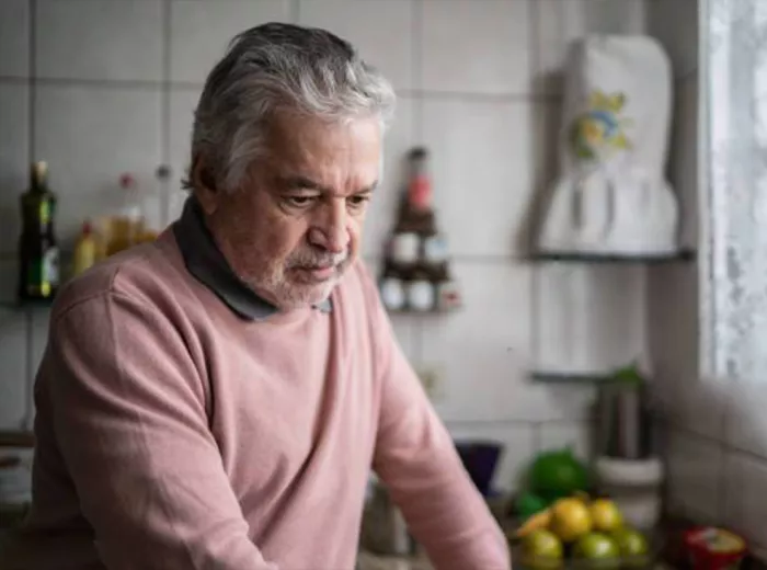 Distressed Hispanic man in a kitchen