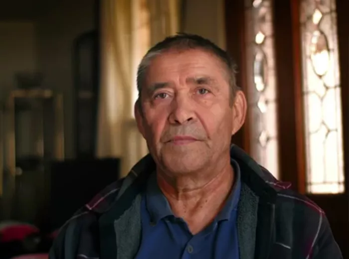 Hispanic man sitting in a dimly lit room