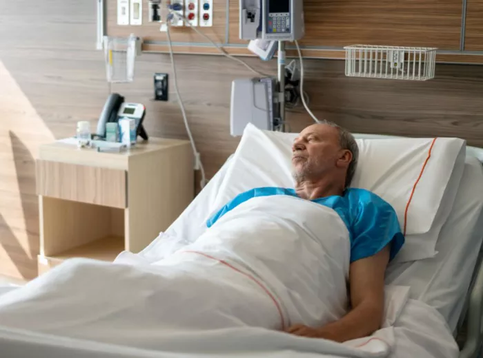 Hispanic man in a hospital bed