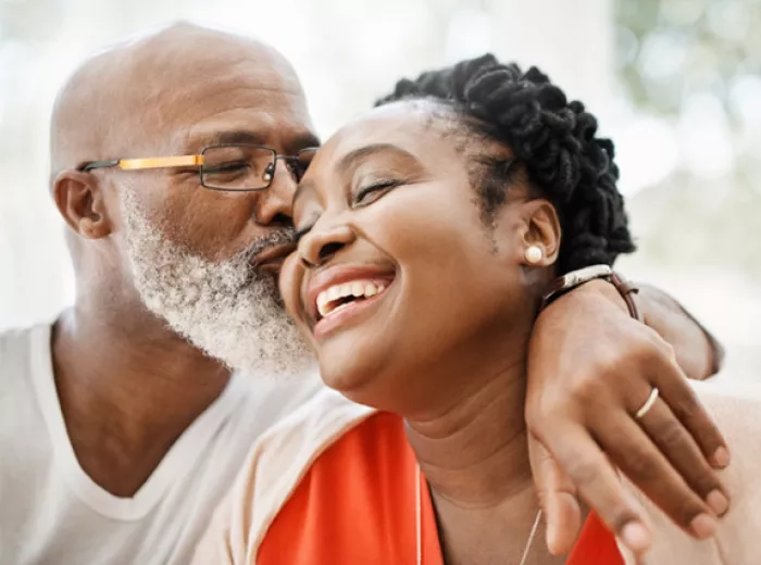 Old man giving a woman a kiss on the cheek
