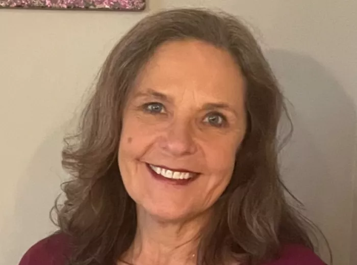 Picture of woman with white wall background