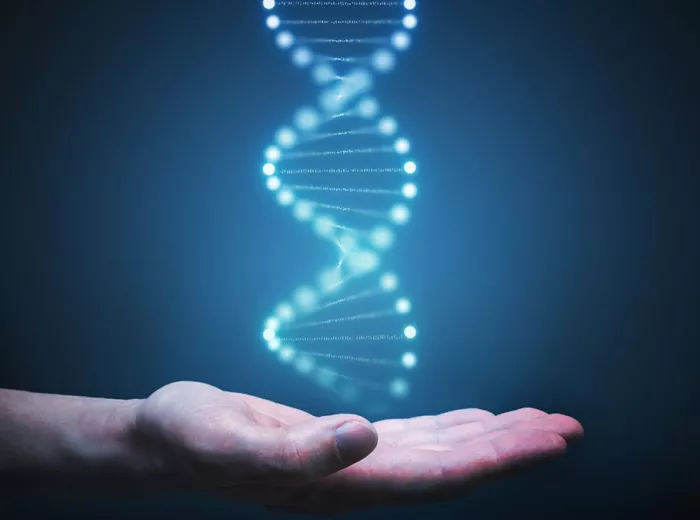 A hand underneath a blue glowing DNA strand