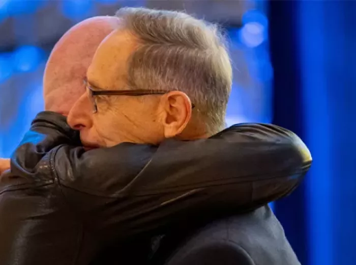 two men hugging at event
