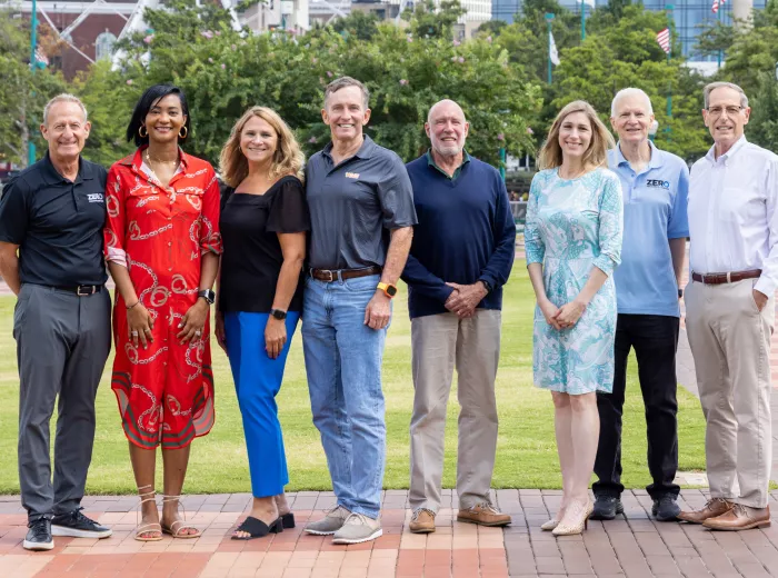 A group of professionals standing outside in a park